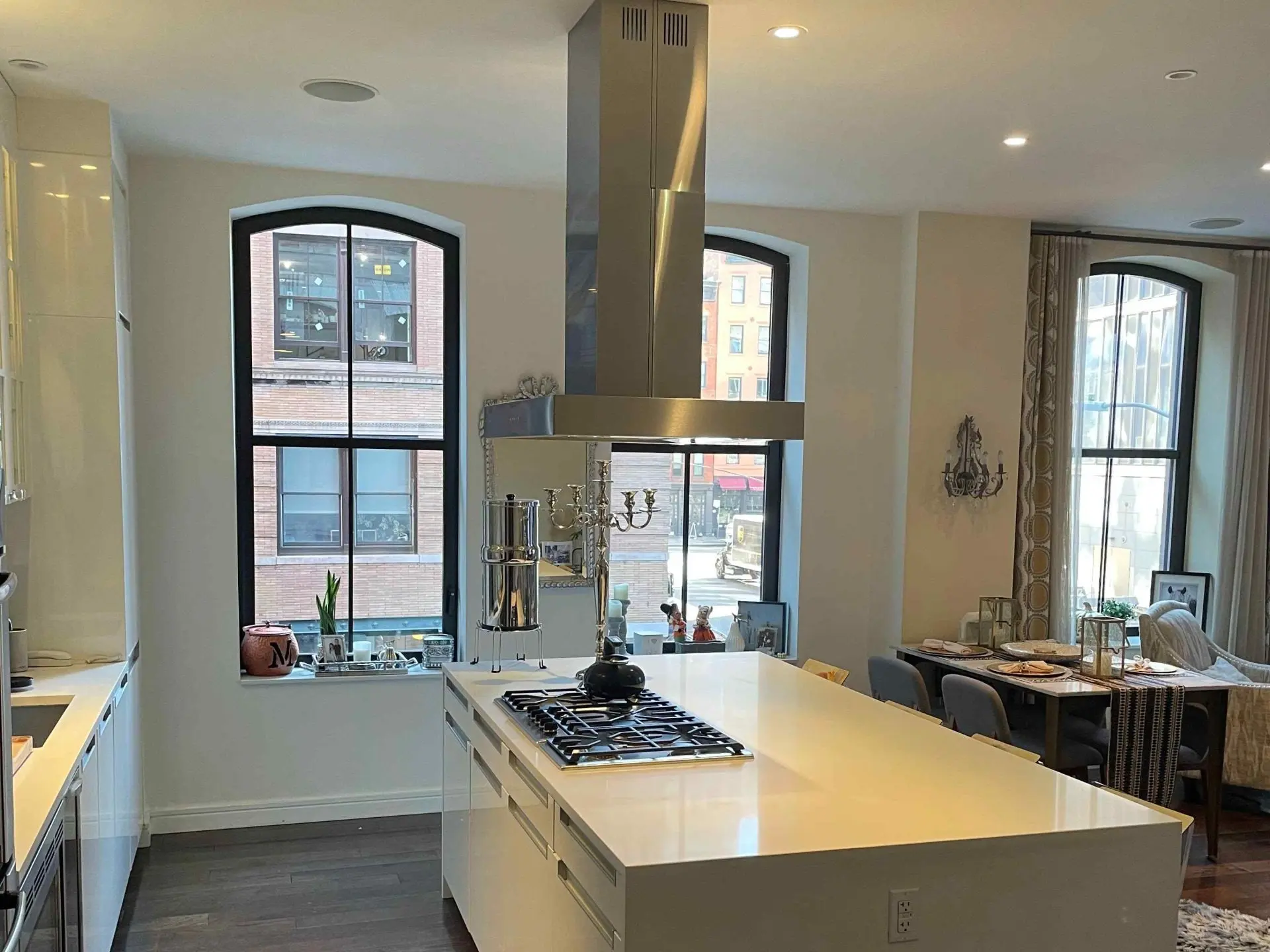 Kitchen with arched windows and a vented hood